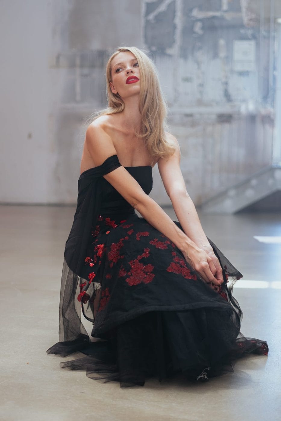 Blonde woman in a black floral gown in raking light, Vika Falileeva (@vikafalileeva)