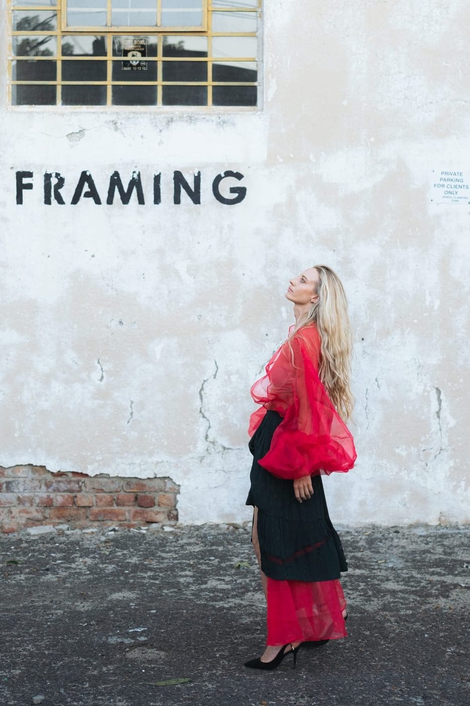 Woman in a sheer red blouse and long skirt against a weathered Paris wall, Pascale Fairbairn (@pcfairbairn), Goji Magazine