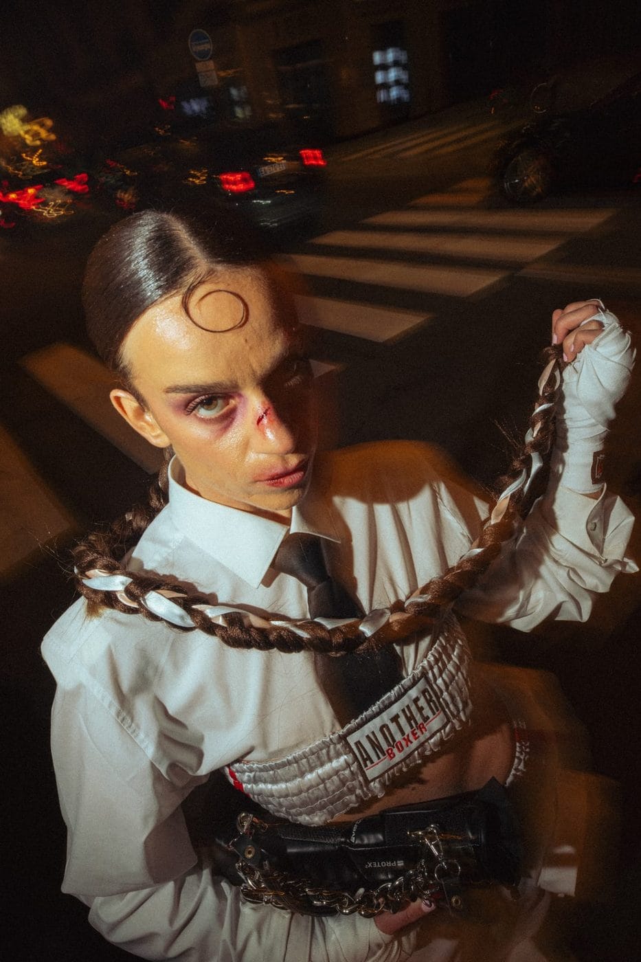Woman with slicked hair, white shirt and braided hairpiece, night street, Joana Bender, La Fripe à Jo (@lafripeajo), ses propres créations